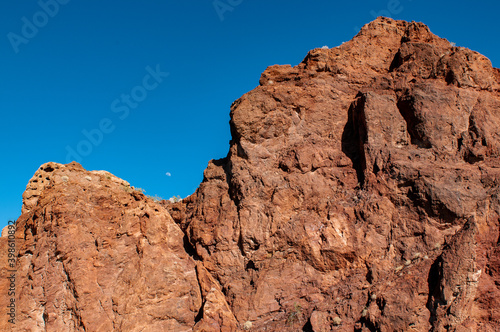 moon over red mountains in the desert