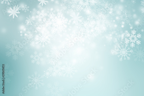 White Xmas Bokeh blur background. Circle light on blue backdrop. Snowflake abstract light wallpaper. © ooddysmile