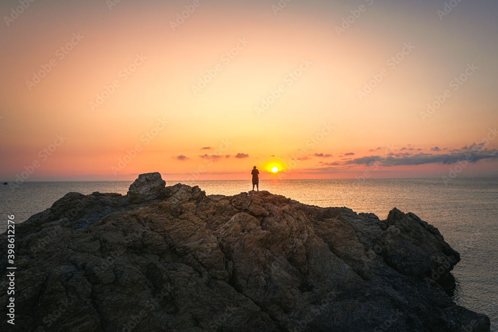 Alone person on stone at Paralia Paltsi beach, Magnesia, Greece