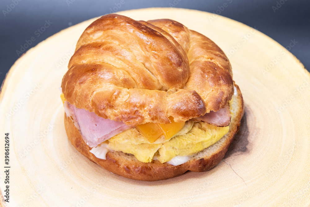 Fototapeta premium Delicately prepared Mexican breakfast croissant sandwich with eggs and ham to start off your day eating right.