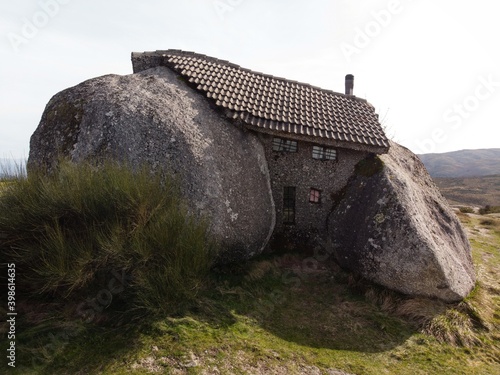Casa do Penedo House museum built between two stone rocks boulders architectural monument near Fafe in Northern Portugal photo