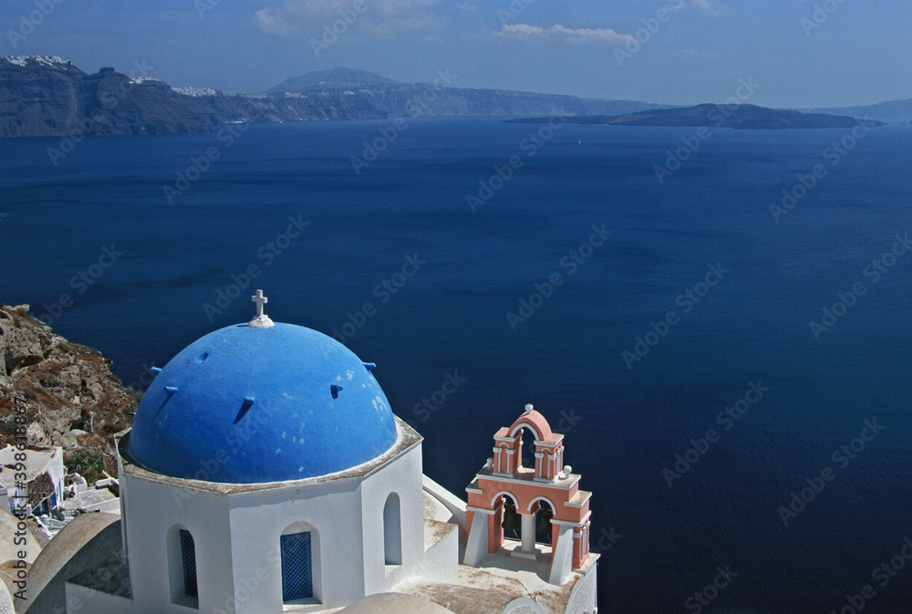 View of Santorini blue domed church and Church bells with  caldera in Santorini, Greece. 