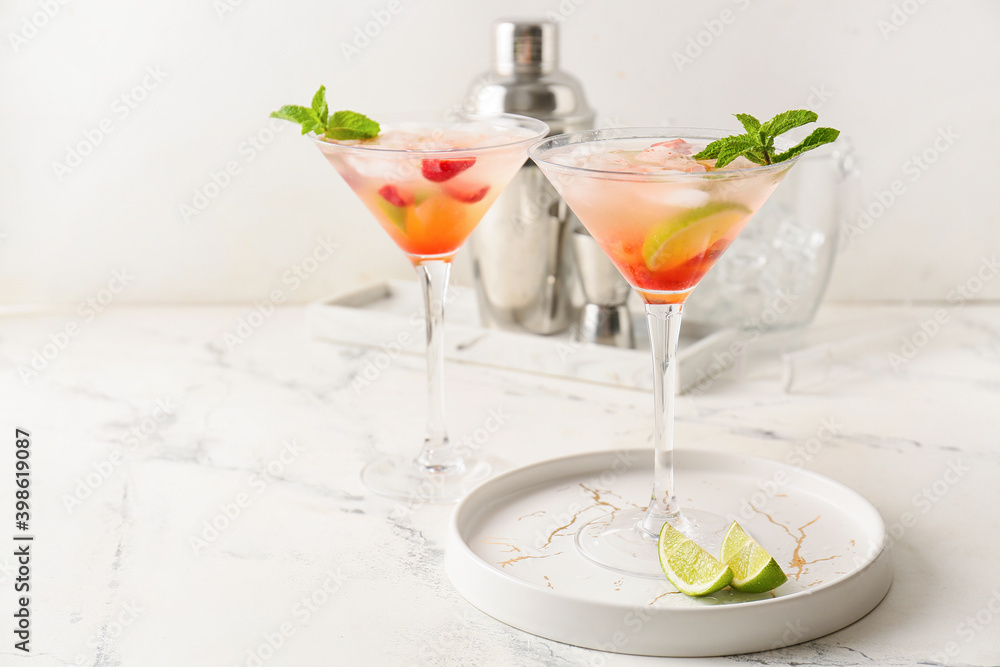 Glasses with strawberry mojito on table