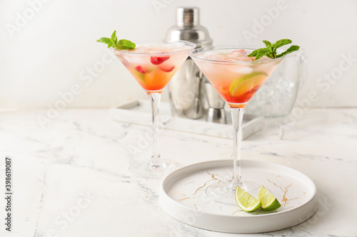 Glasses with strawberry mojito on table