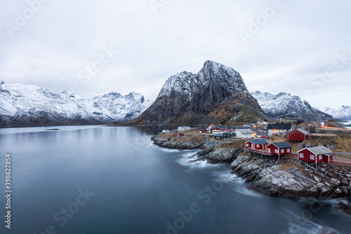 Red fishing house village among the snow with mountain view in Lofoten island Hamnoy Norway © magneticmcc