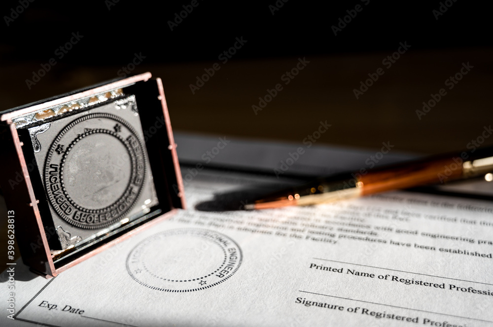 Selective focus on generic professional engineer, architecture. or surveyor stamp and certification statement Selective focus on generic professional engineer, architecture. or surveyor stamp and certification statement