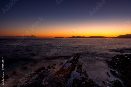 Sunset or Dusk seashore or beach from Alghero, Sardinia Italy travel and tourissm