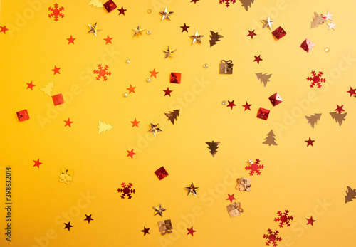 Christmas sparkles in the form of a Christmas tree  gifts  stars on a yellow background. High quality photo
