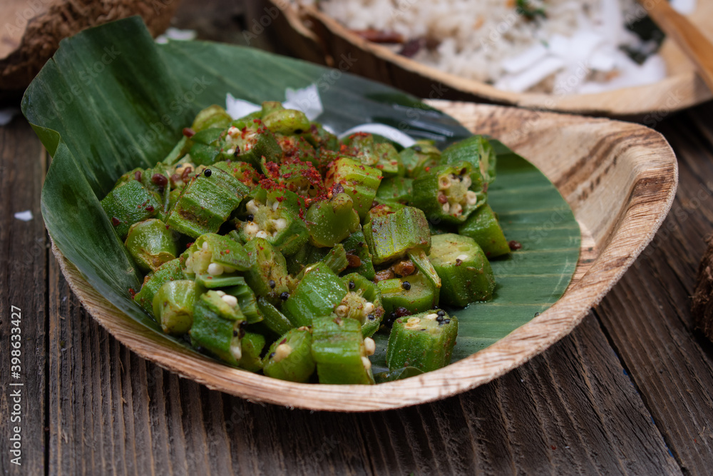 Okra curry served on banana leaf in sustainable plate Okra curry served on banana leaf in sustainable plate