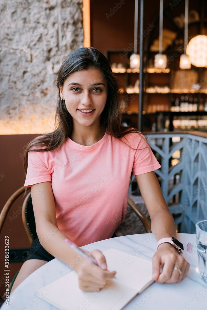 Writing dairy on notebook in coffee shop, concept as memory of life.