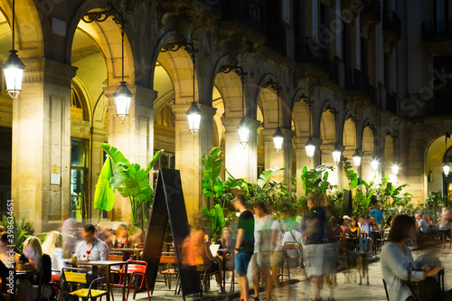 View of illuminated Placa Reial in Barcelona in warm autumn evening