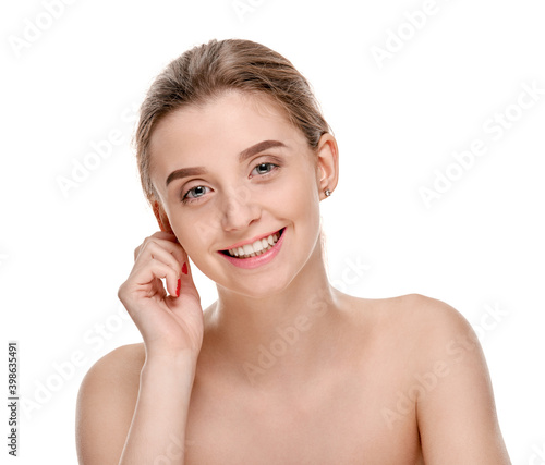 Beautiful smiling girl with clean fresh skin posing on white background