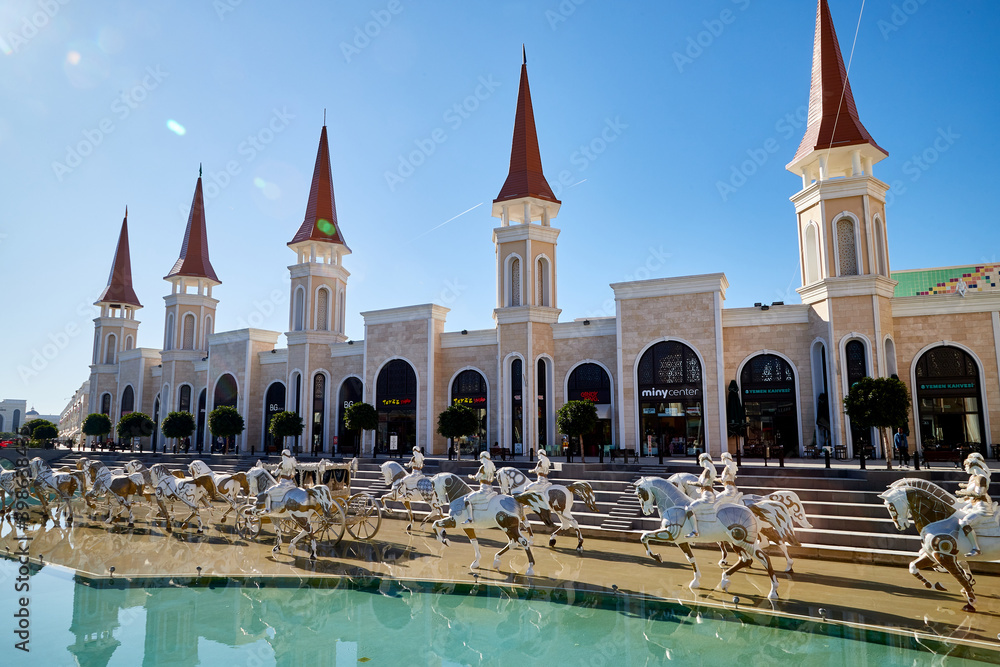 Obraz premium Belek, Turkey - December 17, 2019: Main pool with statues and nice castle in Land of Legends theme mall. Night. A very big hotel, shopping mall and fun park located in Belek, Antalya, Turkey.