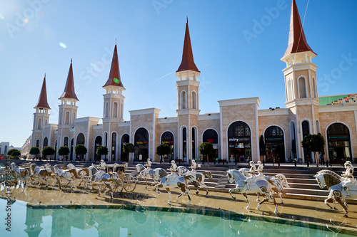 Belek, Turkey - December 17, 2019: Main pool with statues and nice castle in Land of Legends theme mall. Night. A very big hotel, shopping mall and fun park located in Belek, Antalya, Turkey.
