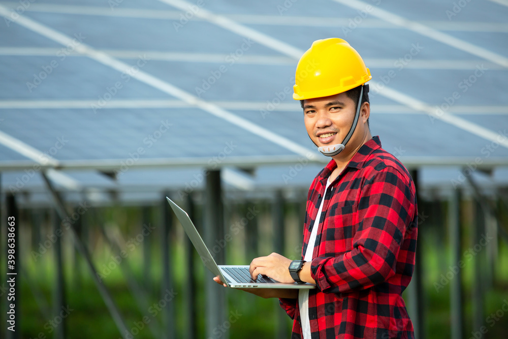 Fototapeta premium Asian engineer working on checking equipment and use a laptop to measure the heat temperature in solar power plant.