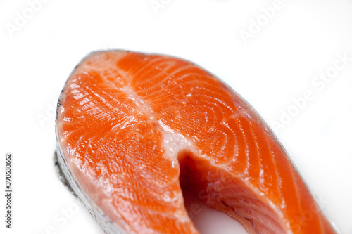 salmon sliced into pieces on white background. red fish. fresh trout for cooking.