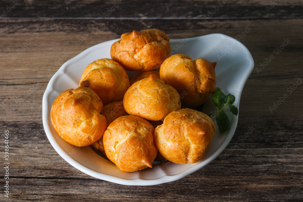Sweet tasty profiteroles heap in the bowl Sweet tasty profiteroles heap in the bowl