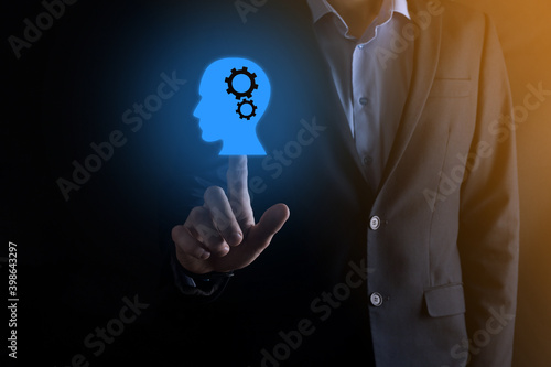 Businessman man holding a man icon with gears in his head. Artificial intelligence. Technology advances. Robot. Contour symbol.