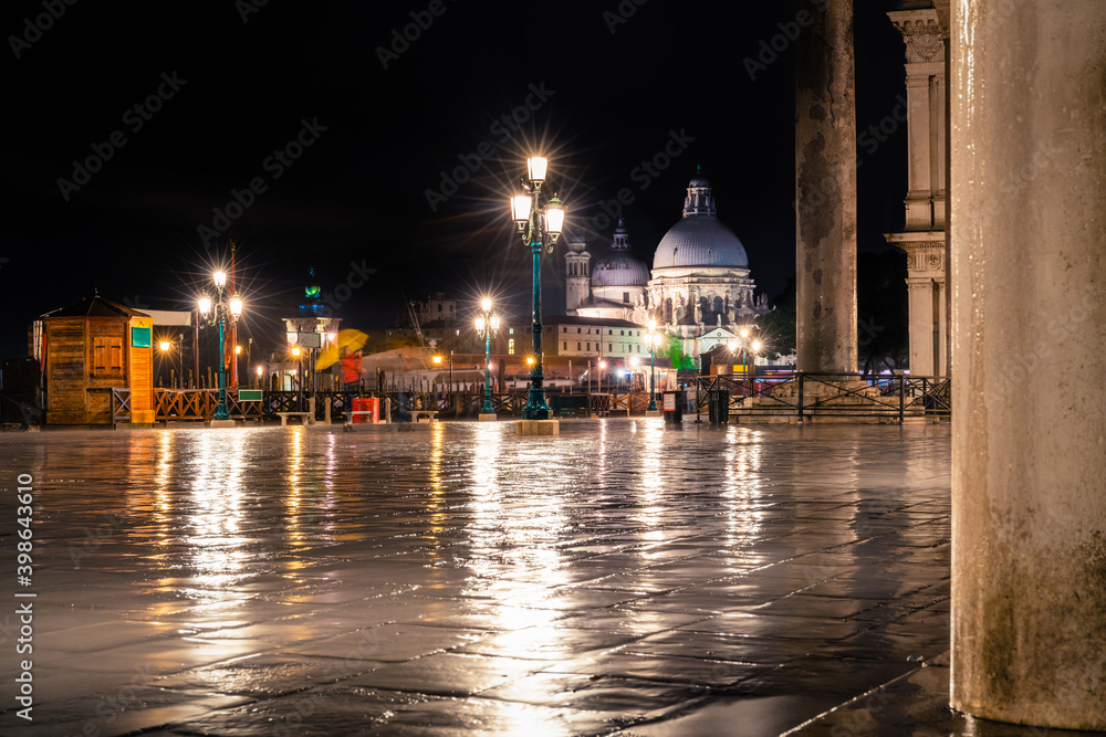 St Marco square overlooking Basilica di Santa Maria della Salute at rainy night
