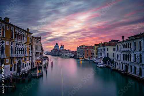 Long exposure view of Grand Canal and Basilica Santa Maria della Salute at sunset in Venice, Italy