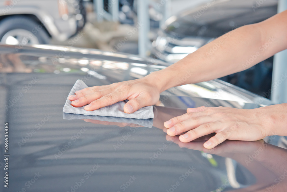 Hand cleaning car with microfiber cloth