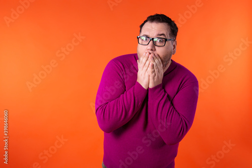 Fear and excited face. Young handsome man with beard wearing casual sweater and glasses. Afraid and shocked with surprise and amazed expression. 