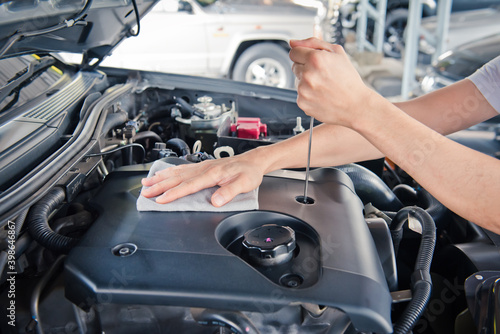 Car service ,fitting a car battery with wrench 