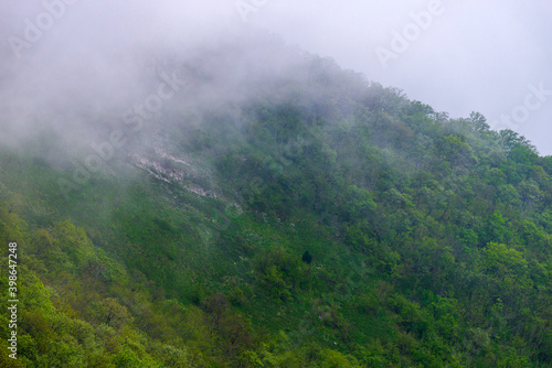 Majestic view on beautiful fog mountains in mist landscape. Dramatic unusual scene. Travel background. Exploring beauty world