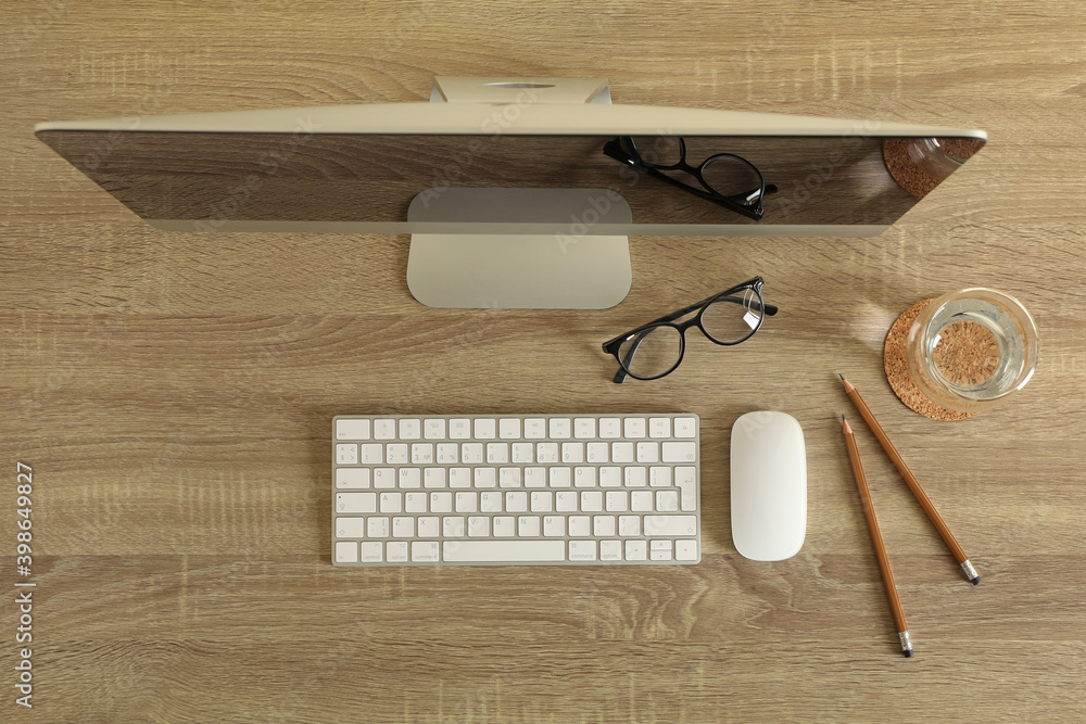 Concept of workplace with modern desktop computer on wooden background Concept of workplace with modern desktop computer on wooden background