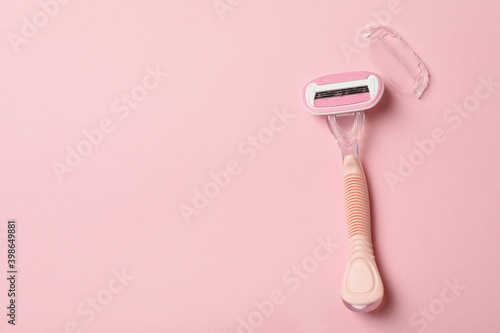 Female razor on pink background, space for text photo