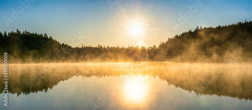 Fototapeta Naklejka Na Ścianę i Meble -  Foggy lake at sunrise in autumn. Swedish landscape