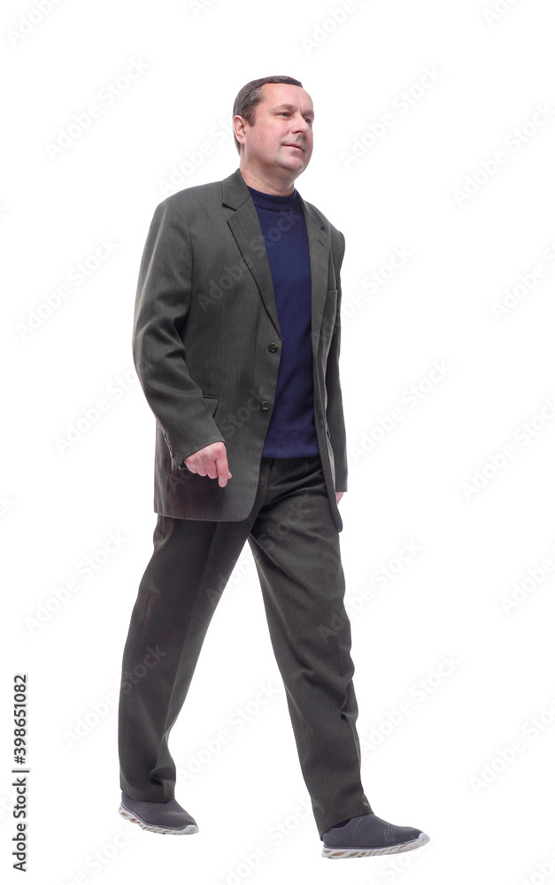 in full growth. confident mature man stepping forward. in full growth. confident mature man stepping forward.