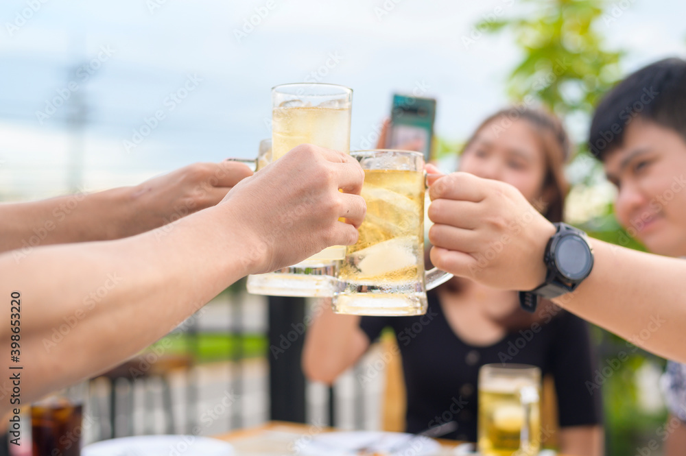 Group of happy friends toasting with a glass of beer, Friendship concept.