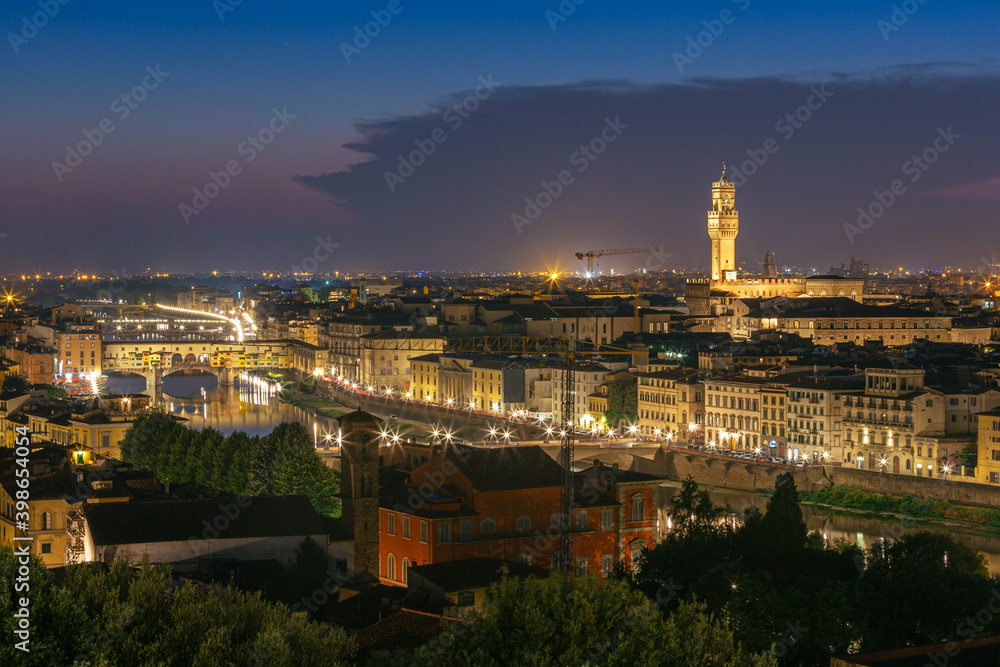 Night view of Florence city skyline with Arno River and Ponte Vecchio