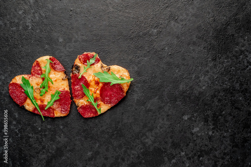 Dinner for two. Two heart-shaped mini pepperoni pizzas with place for text