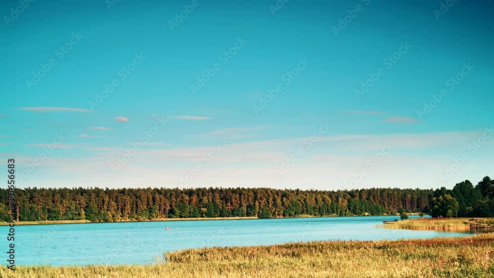 Time lapse of clouds moving over lake Kierwik in Masuria lakeland in Poland. Green summer landscape in Europe. Time lapse of clouds moving over lake Kierwik in Masuria lakeland in Poland. Green summer landscape in Europe.