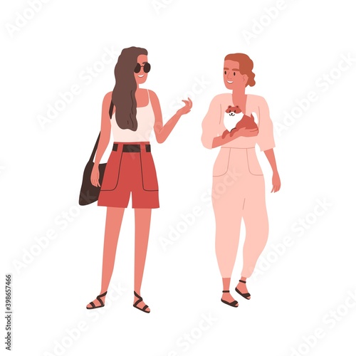 Young smiling women talking and walking together with little funny dog outdoo...