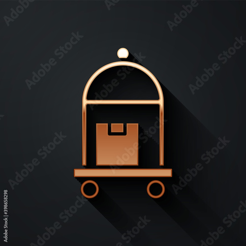 Gold Hotel luggage cart with suitcase icon isolated on black background. Traveling baggage sign. Travel luggage icon. Long shadow style. Vector.