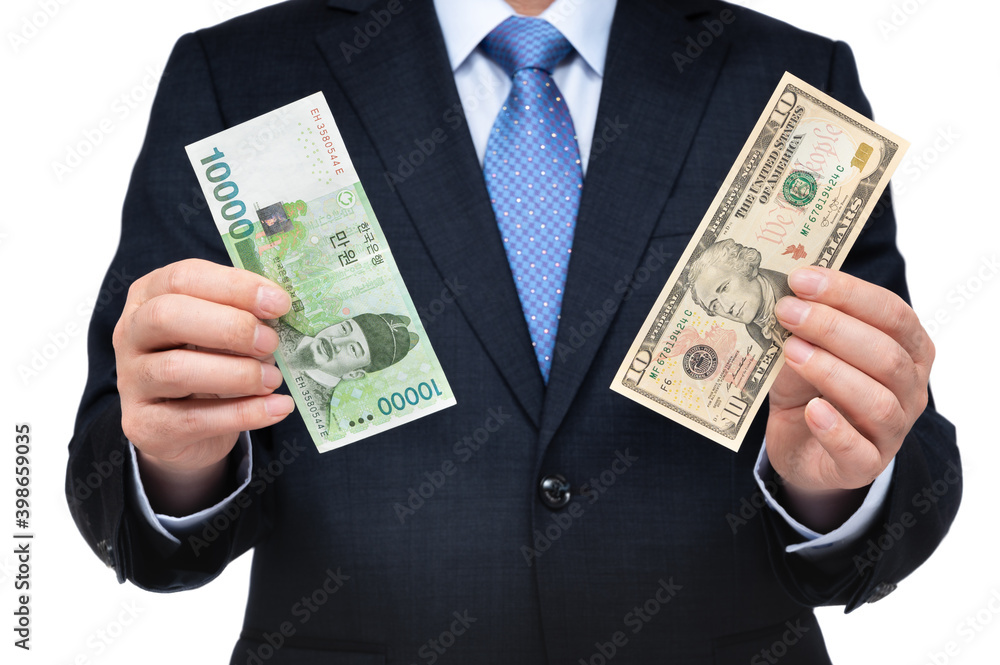 Businessman holding US dollars and Korean currency in hand. Businessman holding US dollars and Korean currency in hand.