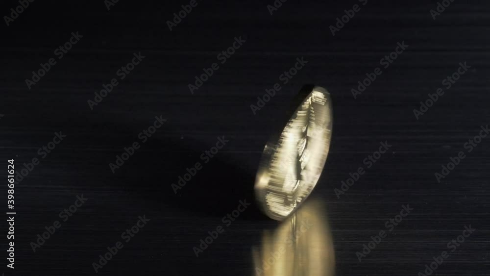 Bitcoins falling on metalic surface Bitcoins falling on metalic surface