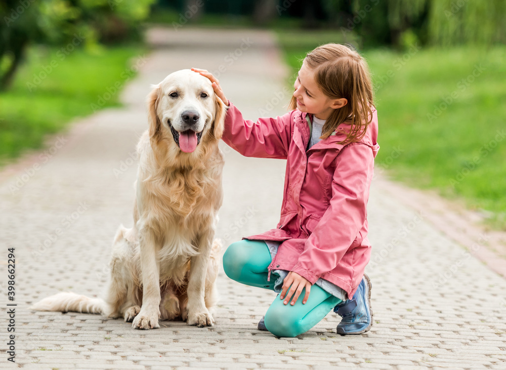 Little girl with golden retriever in park Little girl with golden retriever in park