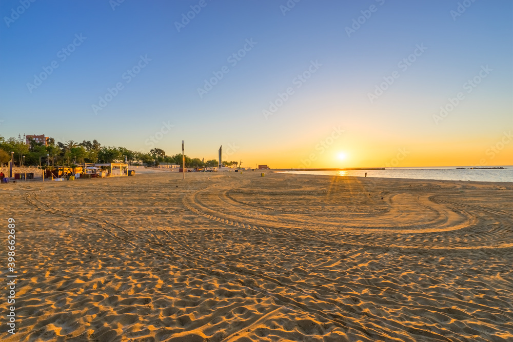 Naklejka premium Barceloneta Beach at sunrise in Barcelona, Spain