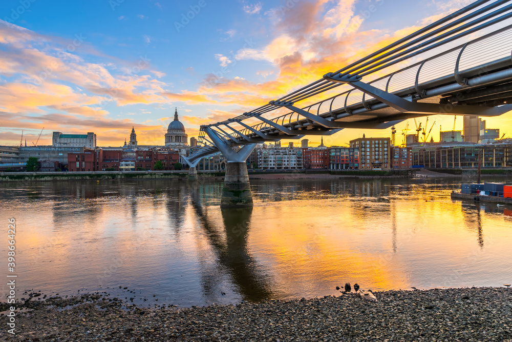 Millennium Bridge and St. Paul's cathedral dome at sunrise