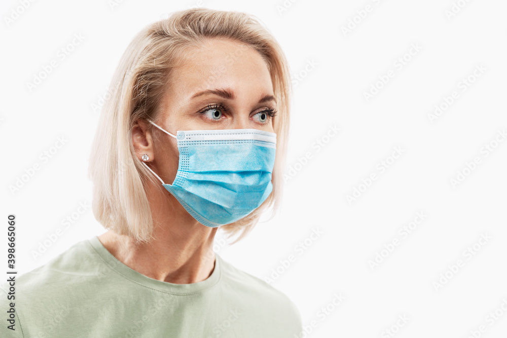 Young blond woman in medical mask. Coronavirus pandemic. Isolated on white background. Space for text. Young blond woman in medical mask. Coronavirus pandemic. Isolated on white background. Space for text.