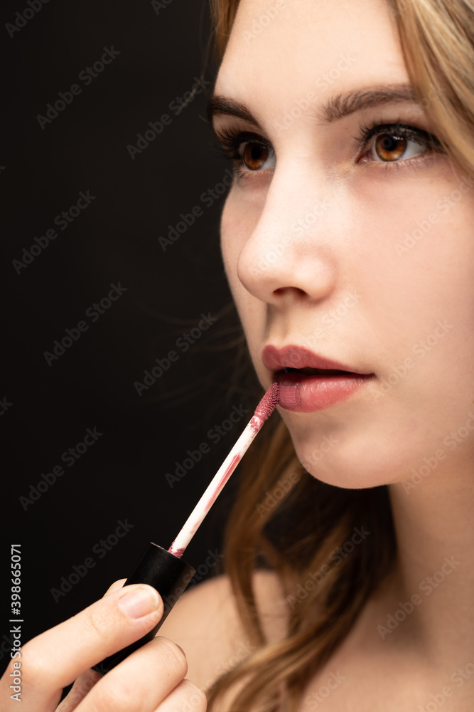 Fototapeta premium Makeup artist alpies lipstick. Make up in process