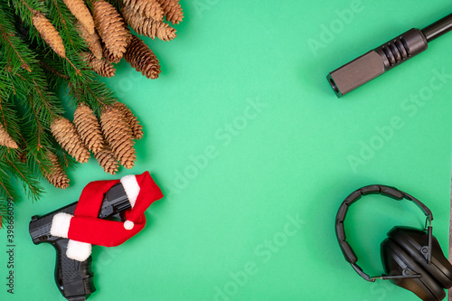 Photo Gun, headphones on a green background. Christmas concept.