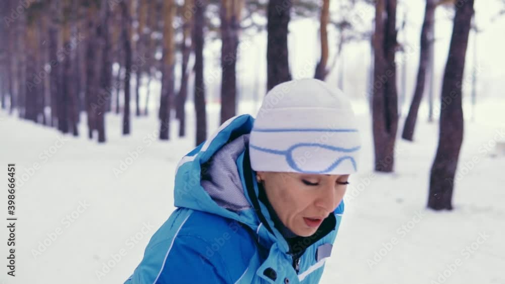 Woman starts training in the winter forest. Jogging outdoors Woman starts training in the winter forest. Jogging outdoors