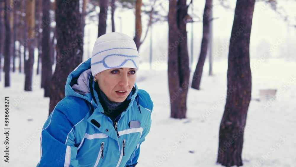 Woman preparing to start in the middle of the winter forest Woman preparing to start in the middle of the winter forest