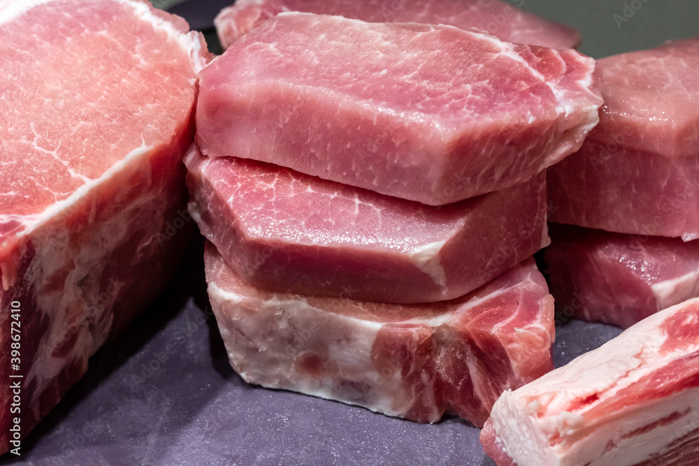 Chopped meat on a kitchen cutting board. Pork with a layer of lard. Chopped meat on a kitchen cutting board. Pork with a layer of lard.