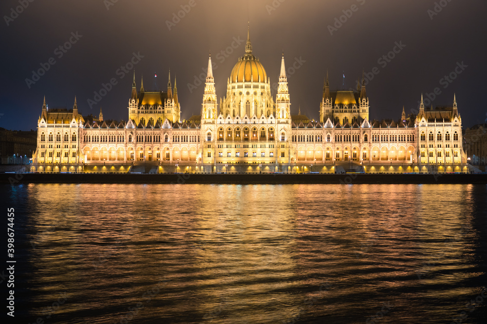 Hungarian Parliament viewed at night on the Danube river in Budapest Hungarian Parliament viewed at night on the Danube river in Budapest